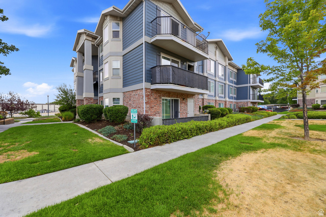 116 East Resaca Drive, Unit F6 Sandy, UT 84070 - Photo 4 of 32 Multi-story building with blue siding, brick accents, and light-colored trim