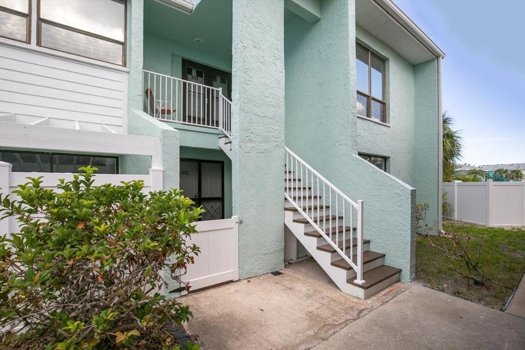 1 Windrush Boulevard, Unit 103 Indian Rocks Beach, FL 33785 - Photo 1 of 1 front view of a house with a yard