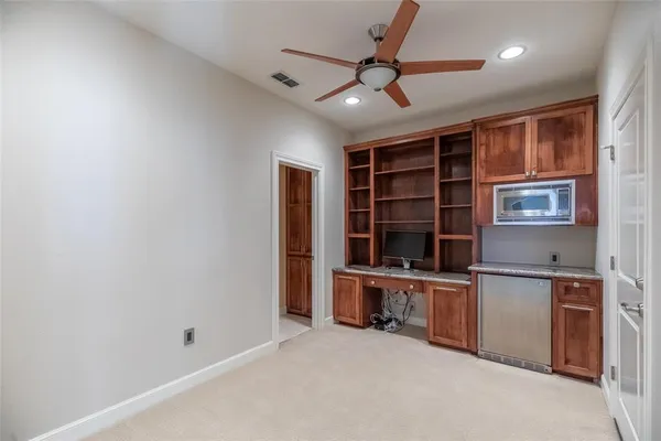 an empty room with windows and cabinet