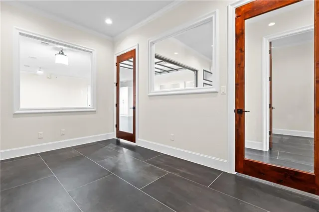 an empty room with windows and closet