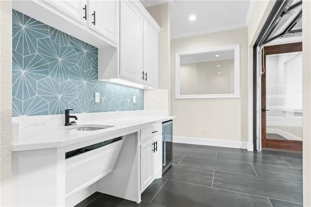 a kitchen with a sink and a mirror