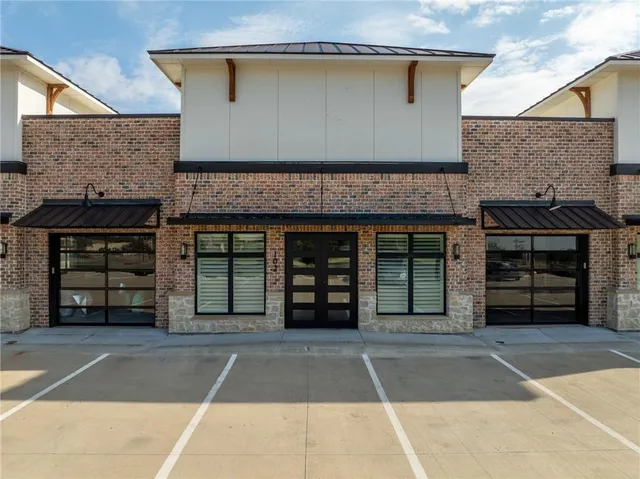a view of a house with a garage and a balcony