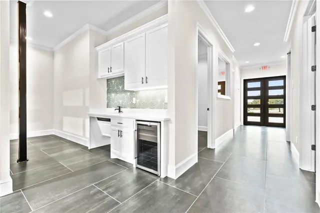 a kitchen with stainless steel appliances a stove top oven a sink and a refrigerator