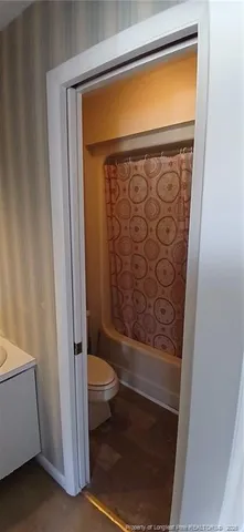a bathroom with a glass door shower and toilet