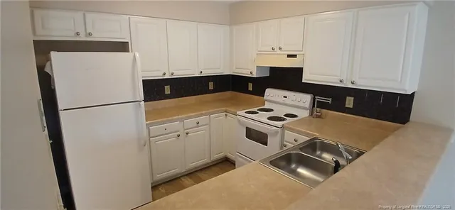 a white refrigerator freezer sitting inside of a kitchen