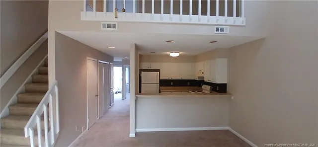 a view of a kitchen with a sink and cabinets