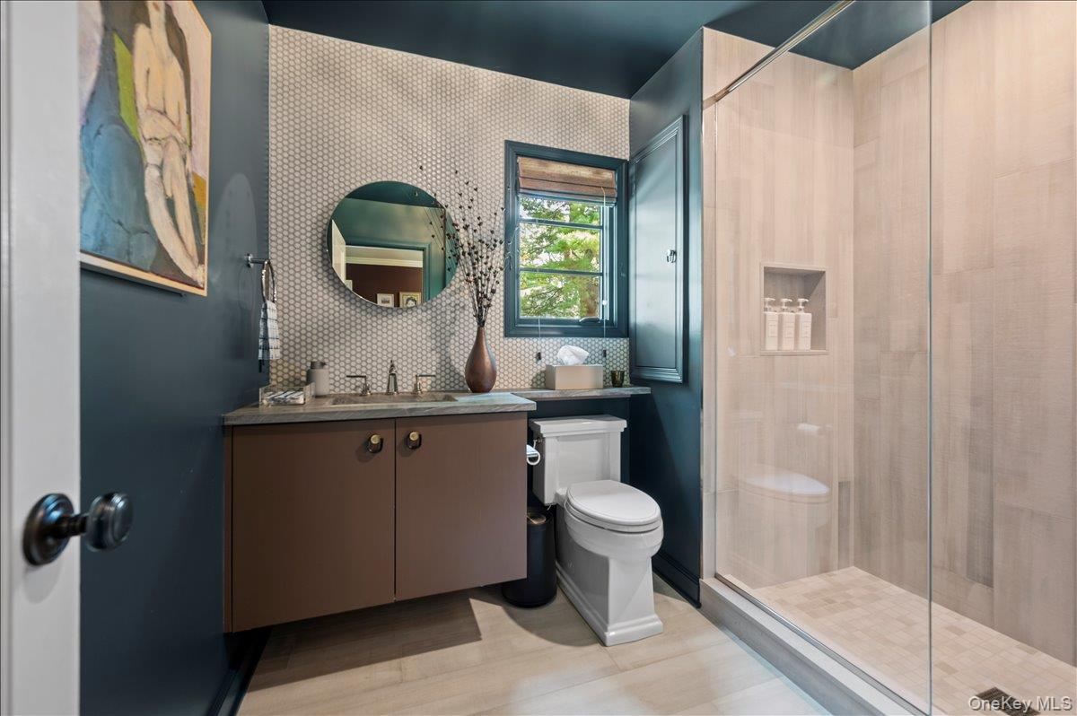 18 South Ridge Road Larchmont, NY 10538 - Photo 16 of 35 a bathroom with a toilet a sink and mirror