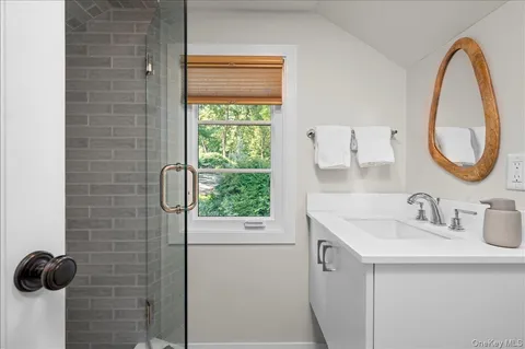 a bathroom with a sink vanity and a mirror