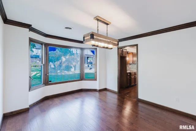 a view of hallway with wooden floor and stairs