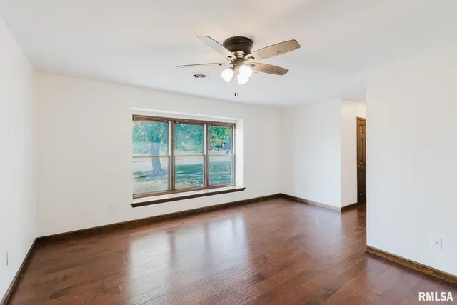 a view of a hallway with wooden floor and entryway