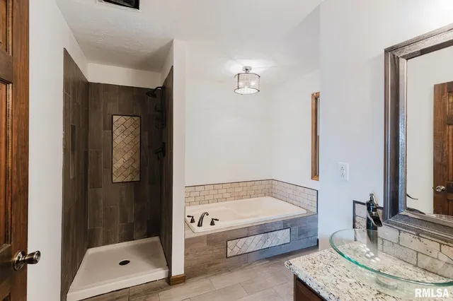 an empty room with windows and ceiling fan