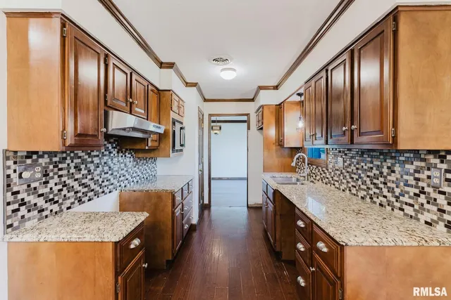 a kitchen with stainless steel appliances granite countertop a stove and a refrigerator