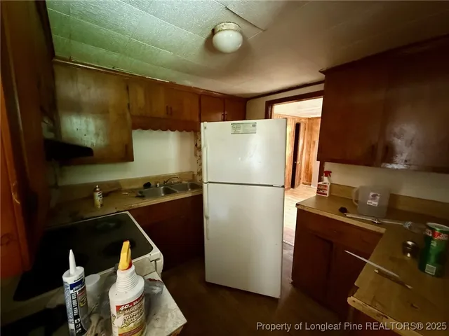 a kitchen with a refrigerator and a sink