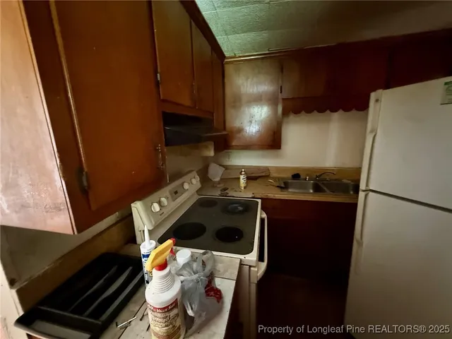 a kitchen with a stove and a refrigerator