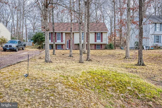 a view of a house with a yard covered in snow