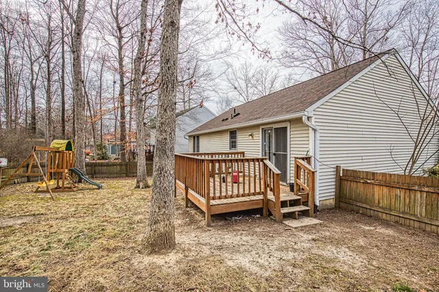 a view of backyard with deck and seating space