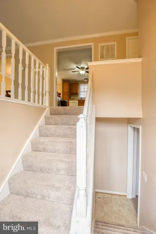 a view of staircase with white walls and a window
