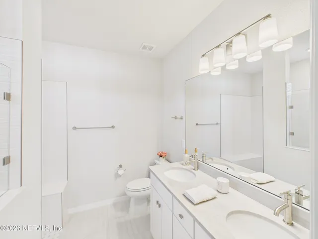 a bathroom with a shower curtain and a shower