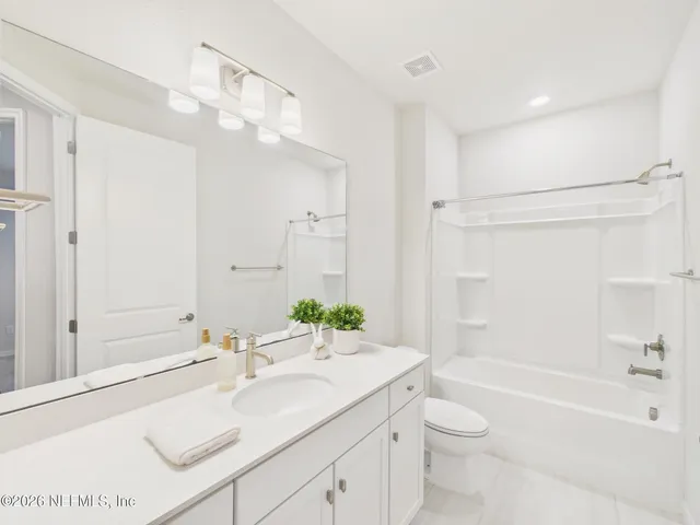 an empty room with window and ceiling fan