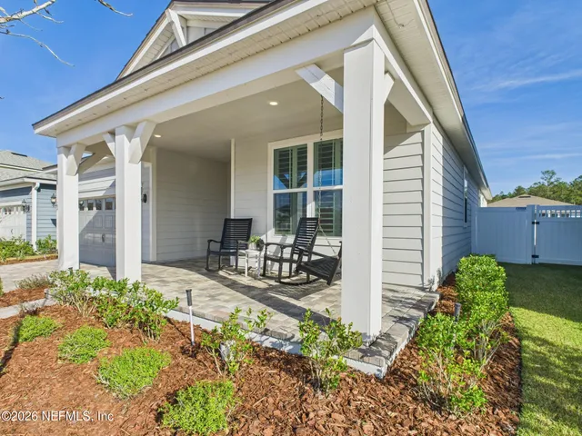 a front view of a house with potted plants