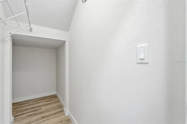 a large kitchen with stainless steel appliances kitchen island a large counter top and a wooden floors