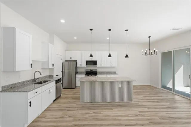 a view of a hallway with wooden floor and entryway