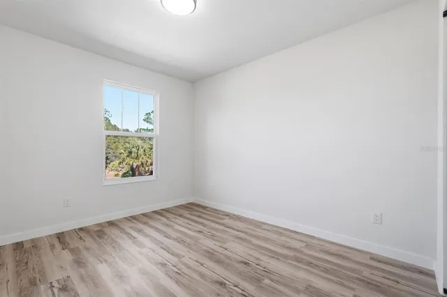 a bathroom with a granite countertop sink and a toilet