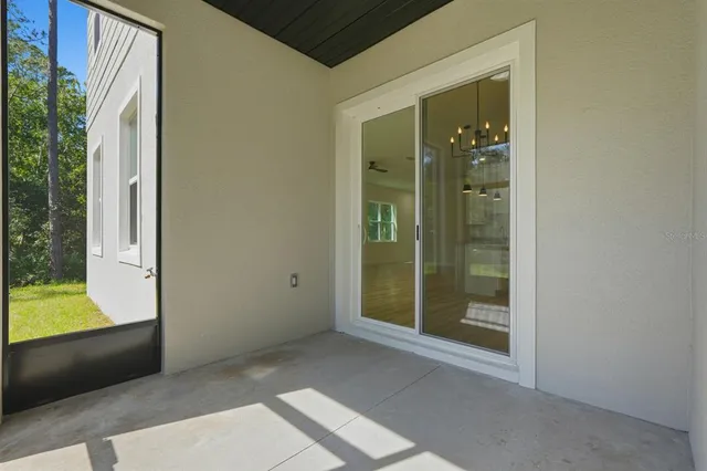 a view of green field with trees in the background