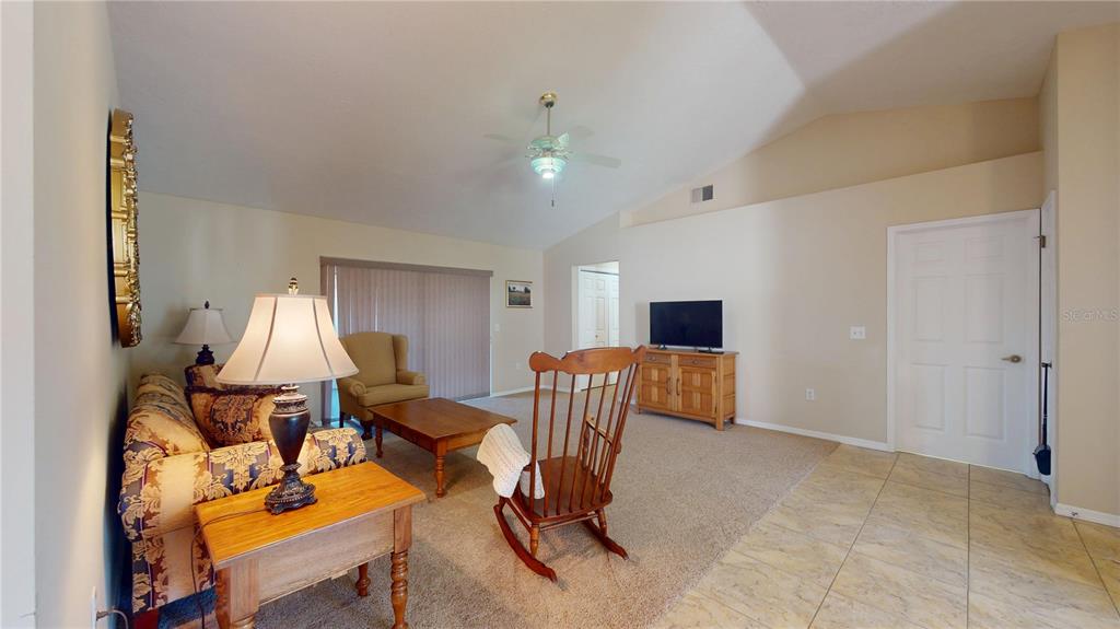 4427 North Bacall Loop Beverly Hills, FL 34465 - Photo 12 of 41 a living room with furniture and a flat screen tv