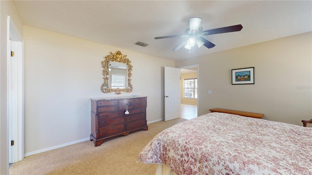 4427 North Bacall Loop Beverly Hills, FL 34465 - Photo 14 of 41 a bedroom with a bed and a dresser