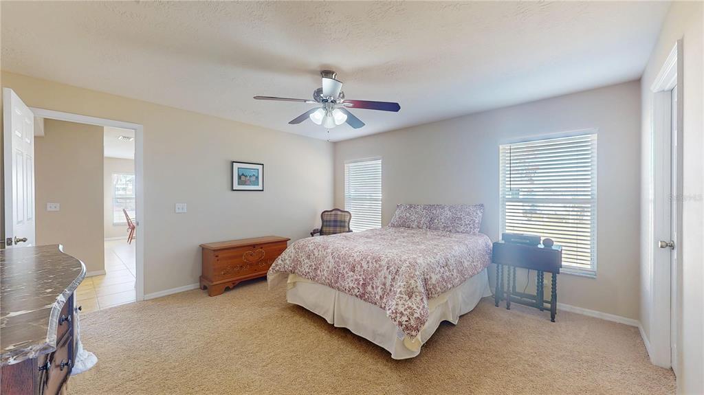 4427 North Bacall Loop Beverly Hills, FL 34465 - Photo 19 of 41 a bedroom with a bed chandelier and a window