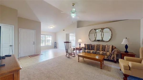 a living room with furniture a rug and a chandelier