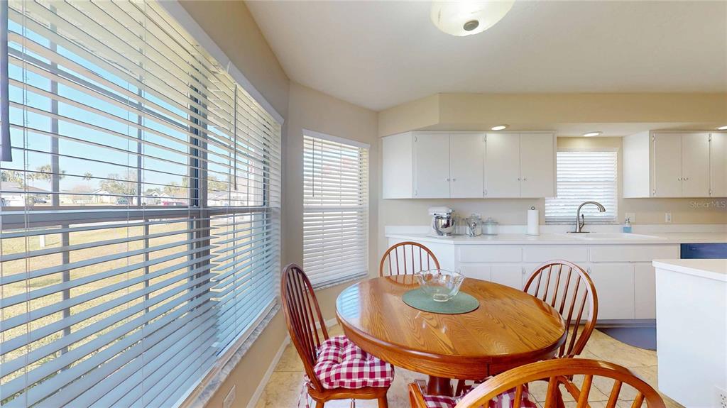 4427 North Bacall Loop Beverly Hills, FL 34465 - Photo 29 of 41 a kitchen with a table chairs sink and cabinets