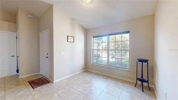 a living room with furniture and a lamp