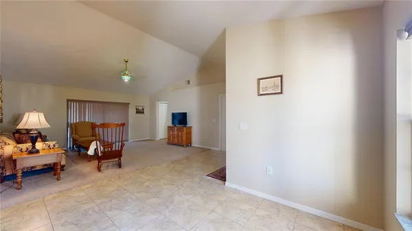 a kitchen with a sink and chairs