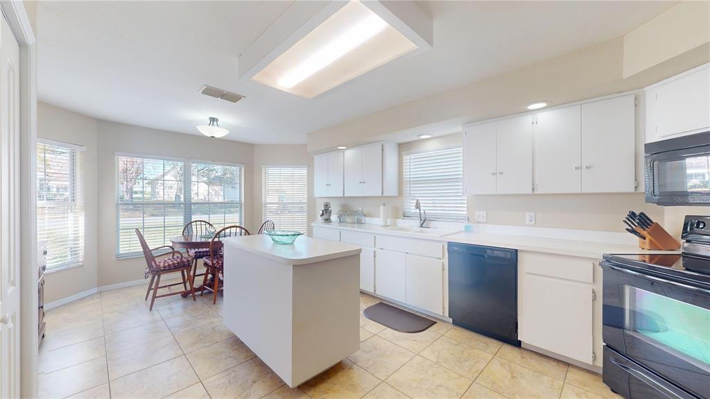 4427 North Bacall Loop Beverly Hills, FL 34465 - Photo 8 of 41 a kitchen with a sink and chairs