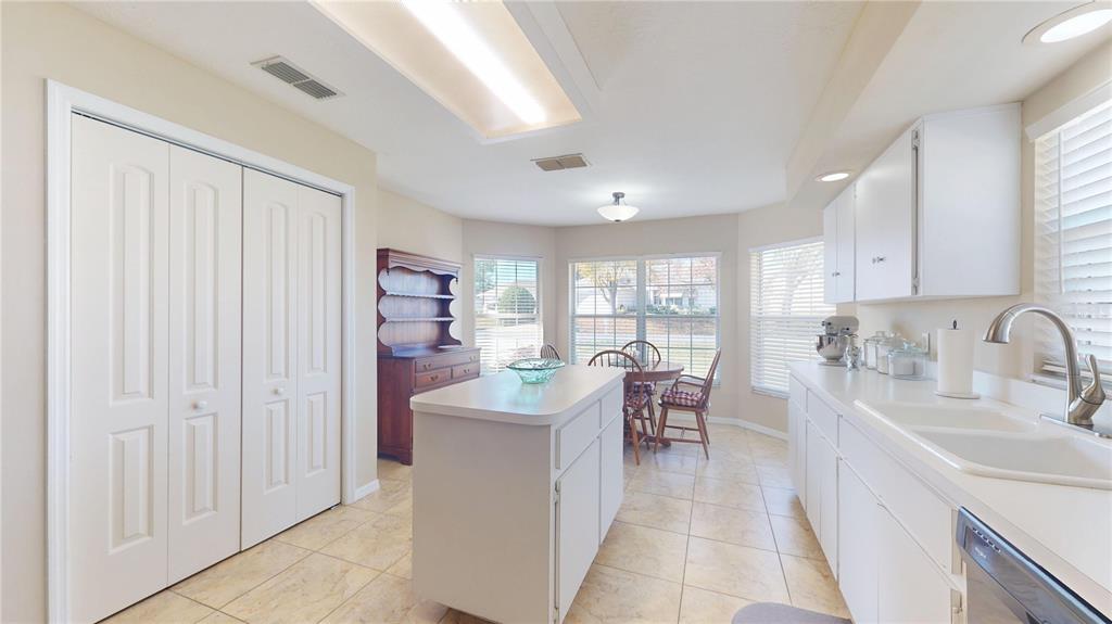 4427 North Bacall Loop Beverly Hills, FL 34465 - Photo 10 of 41 a large white kitchen with cabinets a sink and appliances