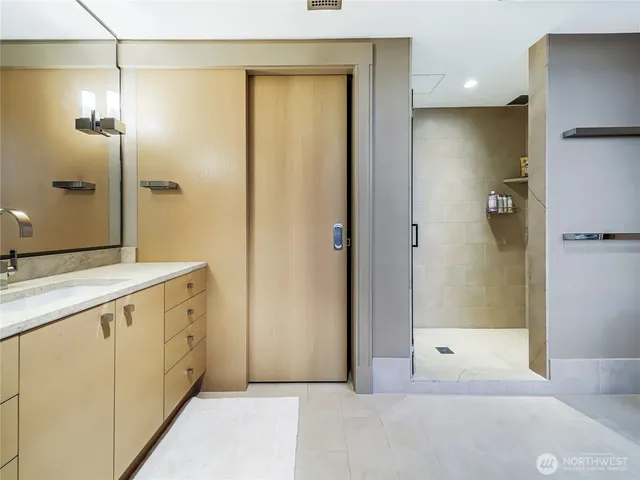 a bathroom with a shower and a sink
