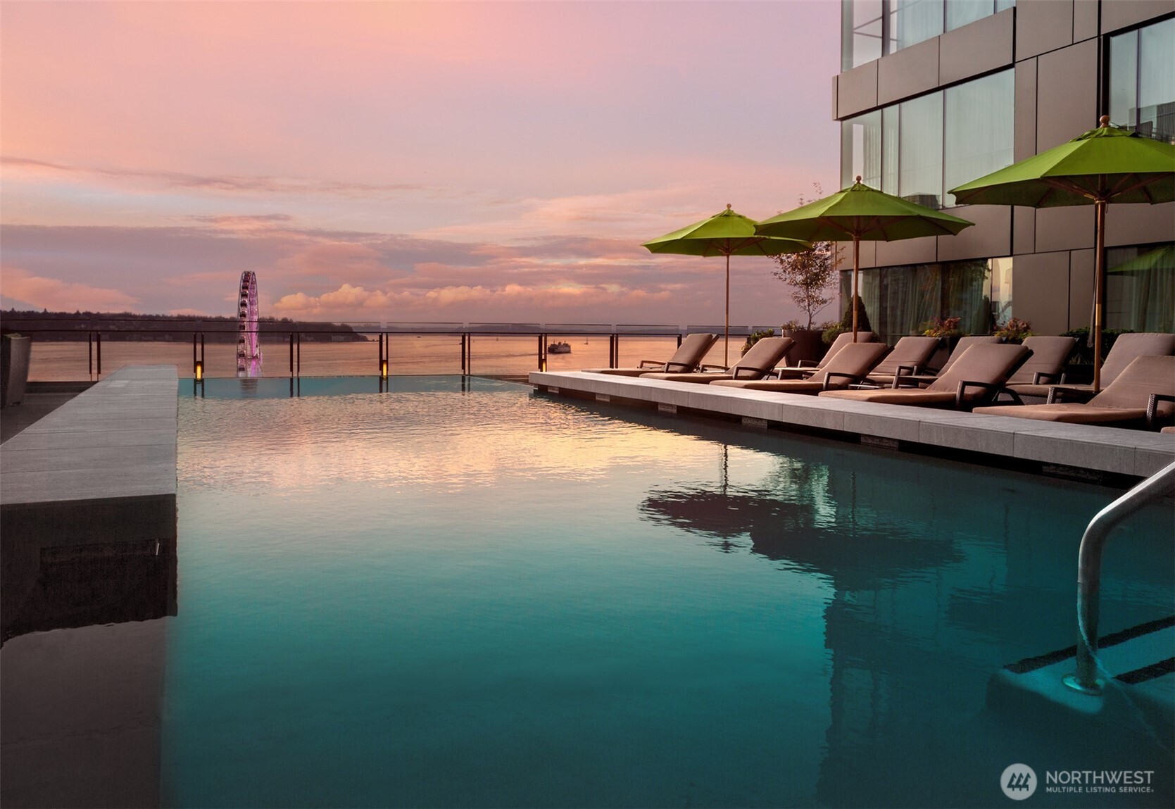 99 Union Street, Unit 1102 Seattle, WA 98101 - Photo 25 of 36 a view of a lake with a table and chairs under an umbrella