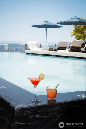 a living room with furniture pool table and a large window