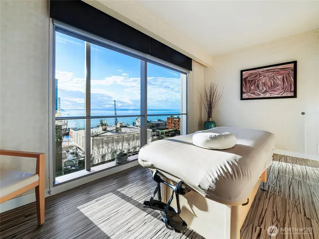 a living room with lots of chairs and chandelier