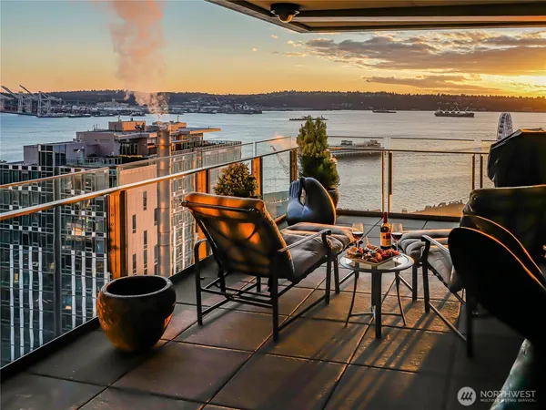 a view of a balcony with chairs and wooden floor