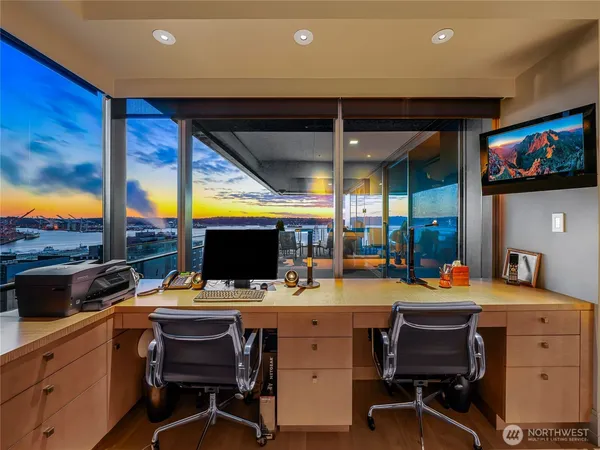 a room with furniture a flat screen tv and a floor to ceiling window