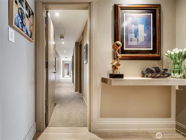 a view of a hallway with paintings on the wall