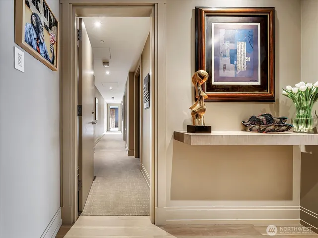 a view of a hallway with paintings on the wall