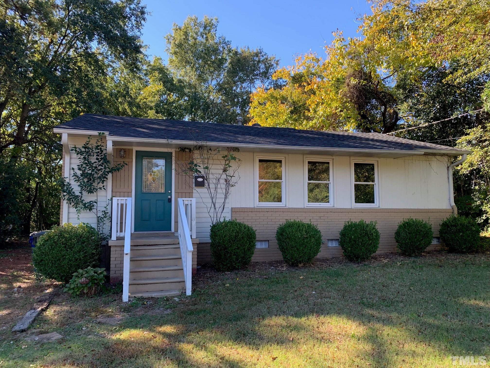 1105 Brighton Road Raleigh, NC 27610 - Photo 2 of 22 a view of a small house with potted plants and a large tree