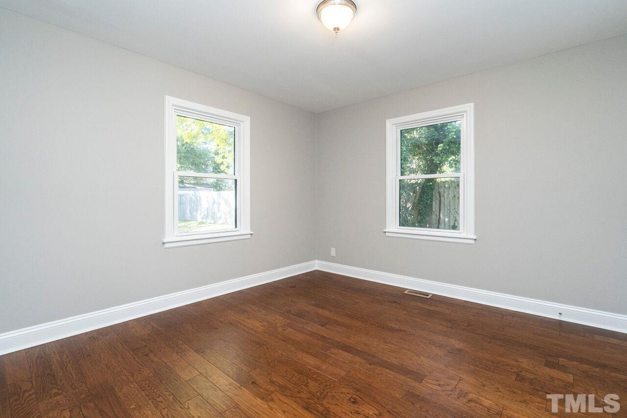 1105 Brighton Road Raleigh, NC 27610 - Photo 12 of 22 an empty room with wooden floor and windows