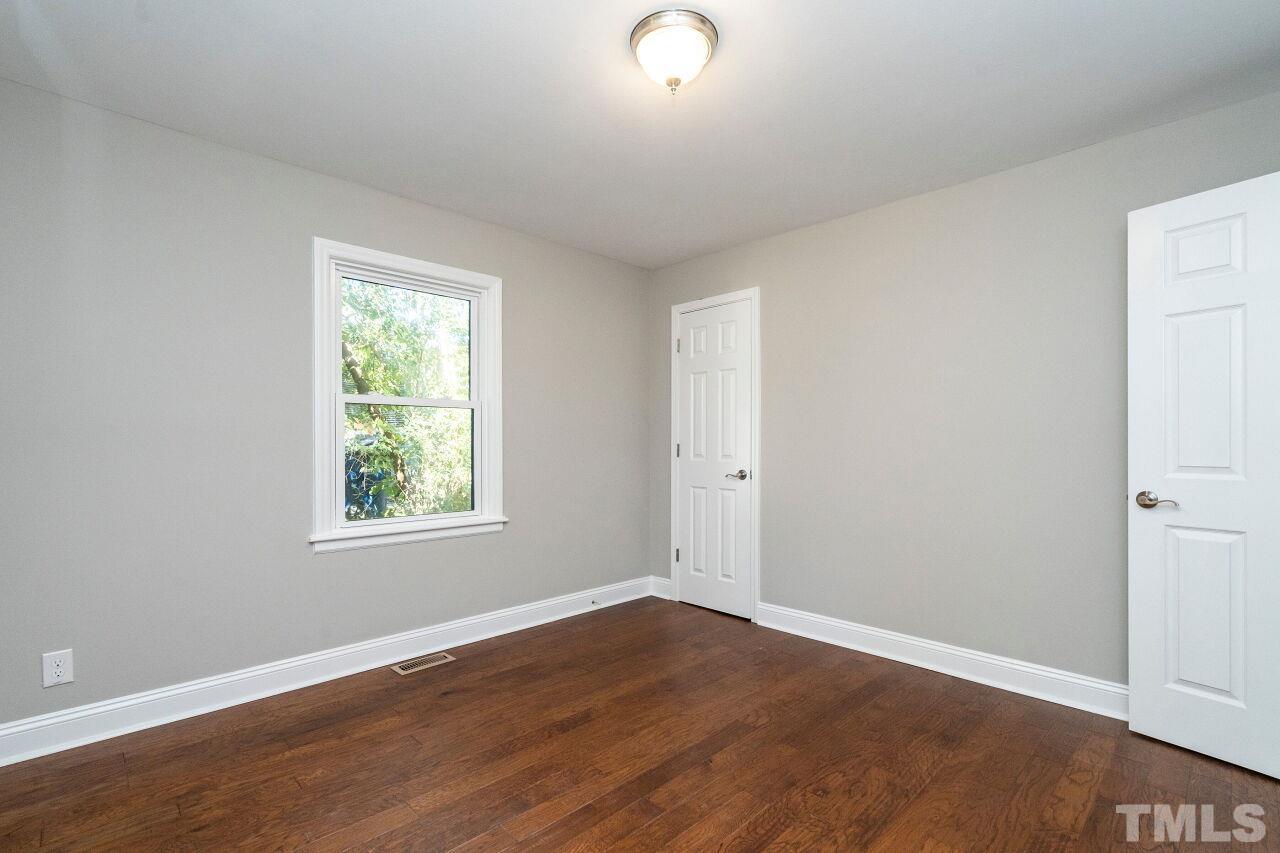 1105 Brighton Road Raleigh, NC 27610 - Photo 13 of 22 an empty room with wooden floor and windows