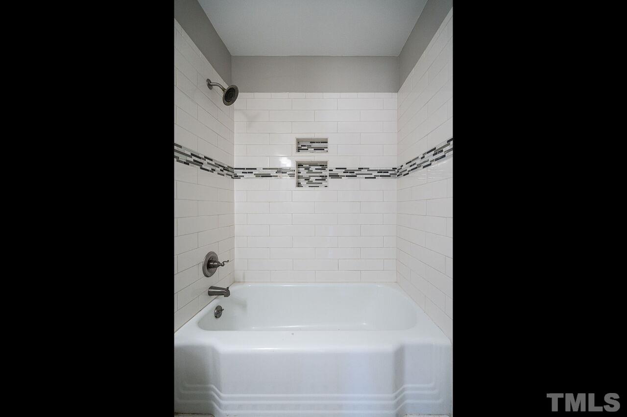 1105 Brighton Road Raleigh, NC 27610 - Photo 15 of 22 a bathroom with a bathtub and a shower
