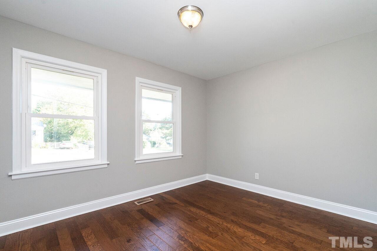 1105 Brighton Road Raleigh, NC 27610 - Photo 16 of 22 an empty room with wooden floor and windows